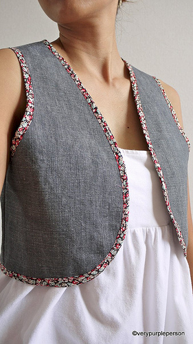 Denim vest with floral bindings